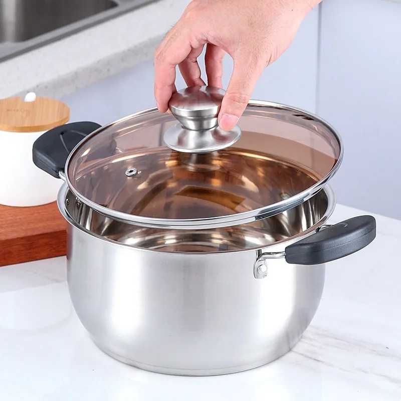 Lifting the tempered glass lid off a pot